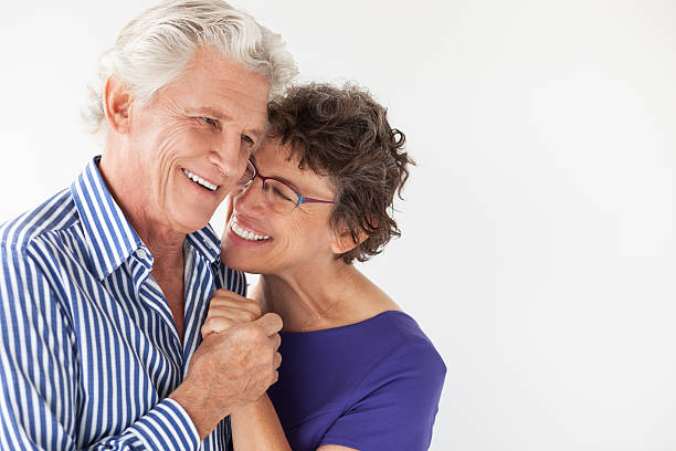 istock Smiling Elderly Couple Smiling and Embracing 636797934