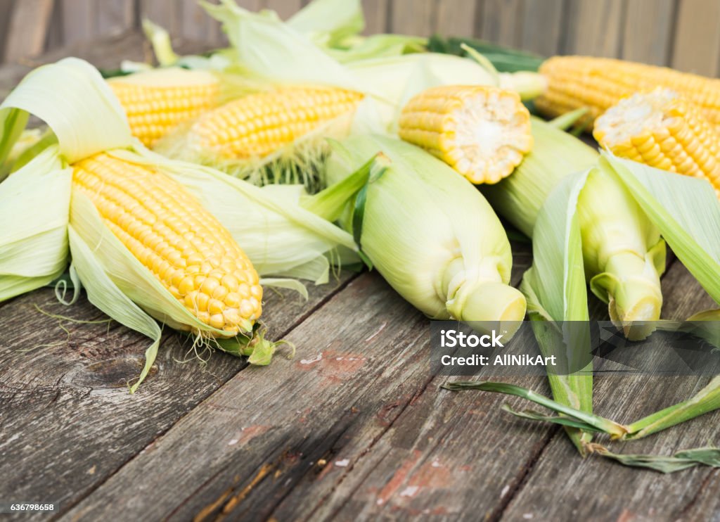 Maize. Fresh Corn on wooden table Cereal Plant Stock Photo