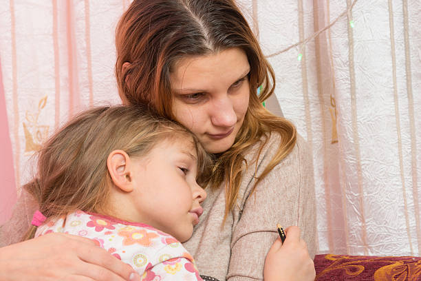 istock Sad five year old girl hugging her mother 636799568
