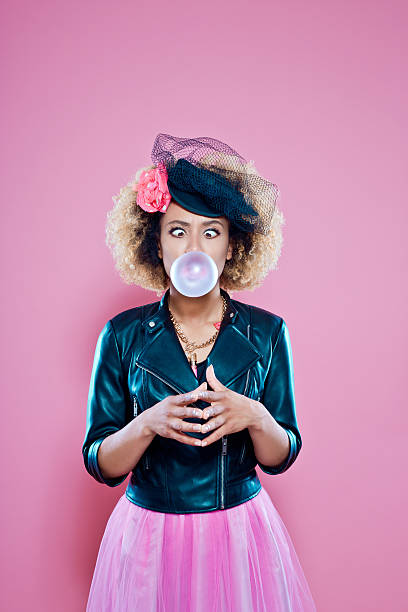 istock Young woman blowing bubble gum 636800878