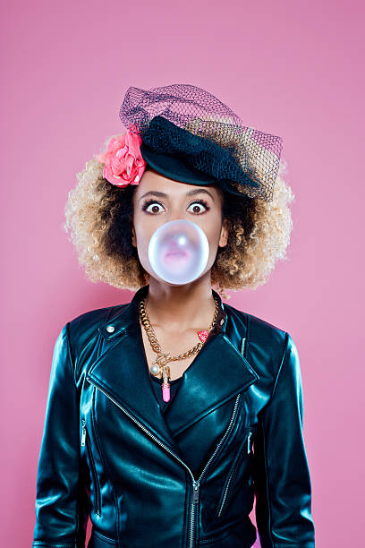 Young woman blowing bubble gum