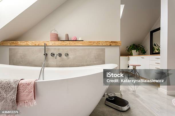Freestanding Bath In Grey Bathroom Stock Photo - Download Image Now - En Suite Bathroom, Bathtub, Scale