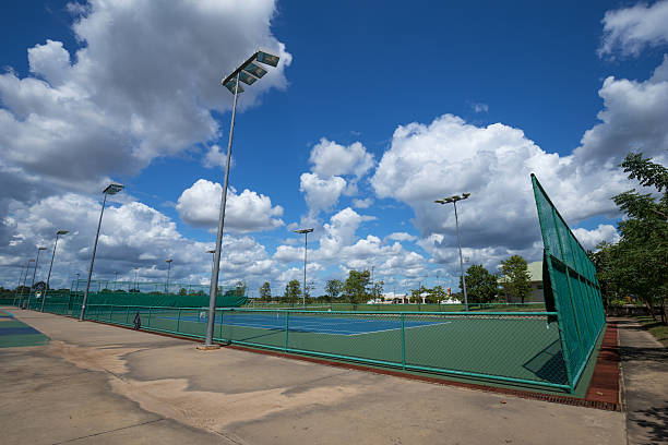 istock outdoor empty tennis court with blue sky 636805992