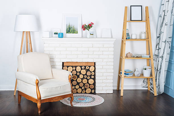 istock Modern light interior with fireplace and cozy white armchair. 636806368