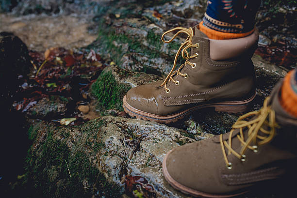 istock Hiking boot closeup on mountain rocks 636807308