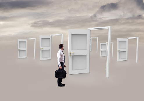 Businessman standing at doorway and looking for opportunities, concept of fresh start
