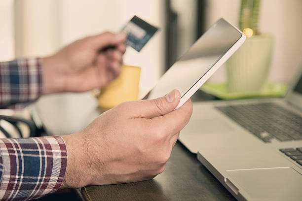 istock Businessman using credit card and digital tablet 636813016