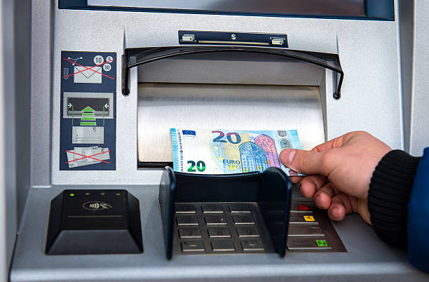 istock Man taking money from atm 636813320