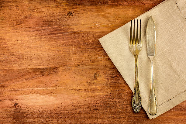 istock Vintage fork and knife on wooden background 636814482