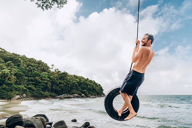 Tyre swing hangs from palm tree island