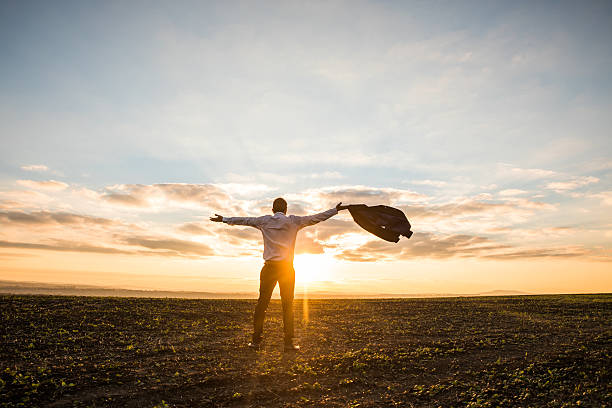 istock Young  executive enjoying his business success in field on sunset 636815794