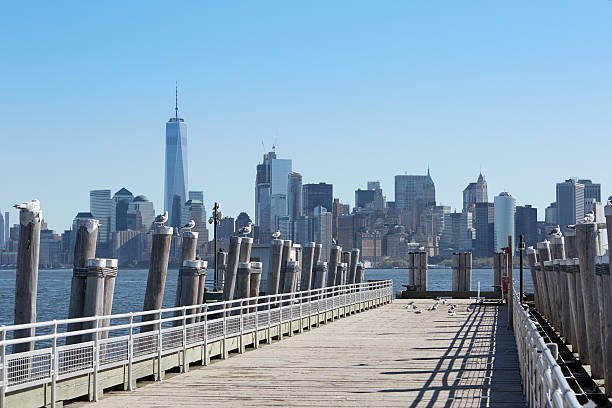 istock Empty pier and New York city skyline view with seagulls 636818812