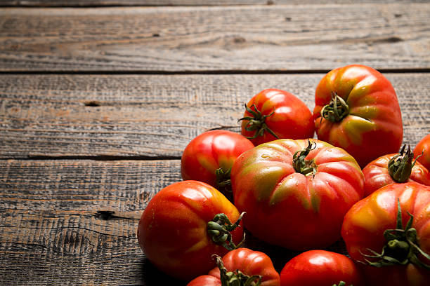 istock Organic raw tomatoes on wood 636820290