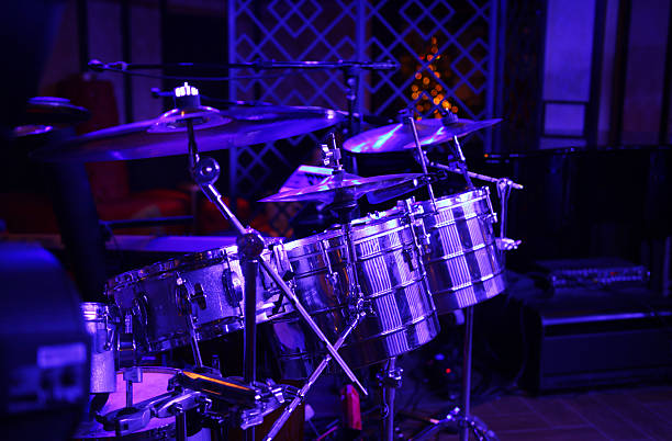 istock Latin band drum kit under purple blue stage lights 636821002