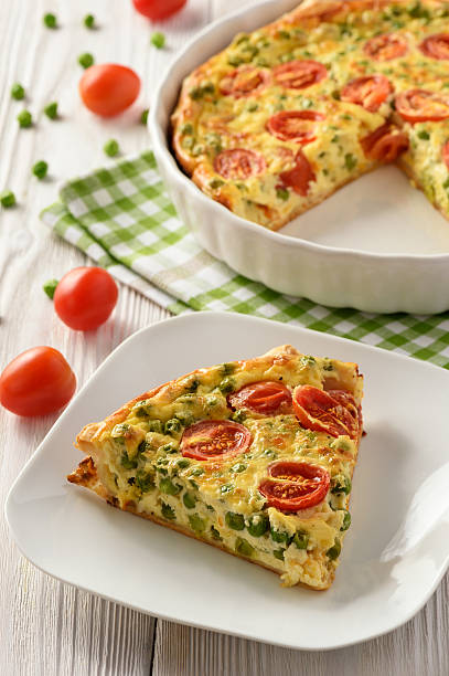 istock Vegetarian quiche with green pea, tomatoes and cheese. 636825494