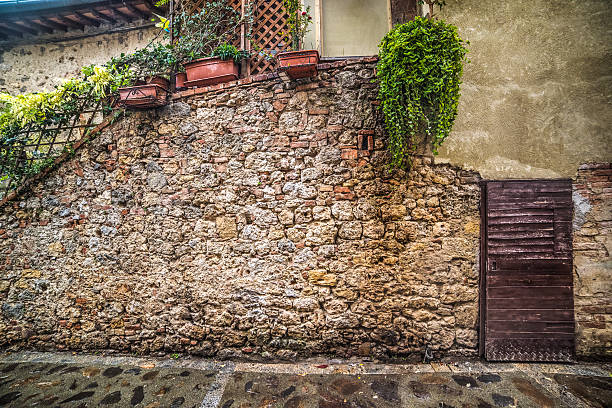 wooden door in a rustic corner in Monteriggioni, Italy. Public place outdoors
