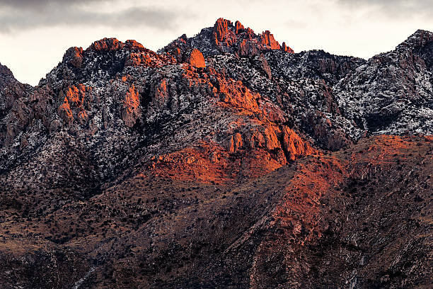 istock Snow capped mountain peaks with sunset alpenglow 636826268