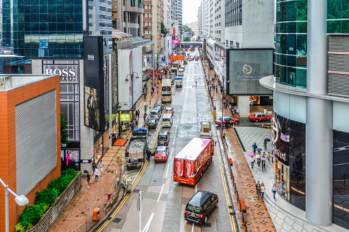 Hong Kong, China - November 23, 2016: Typical street in Kowloon district of Hong Kong. Photo taken during the day and contains many stores and people.