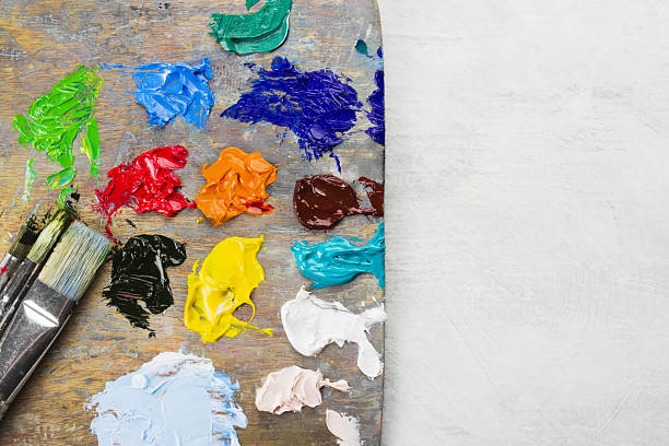 istock Various art oil paints on a wooden palette 636830368
