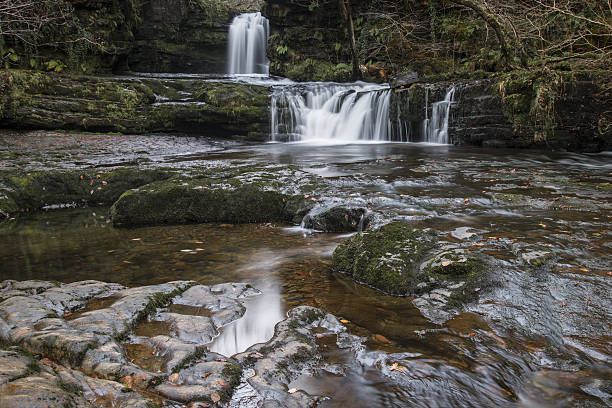 istock Beautiful waterfall landscape image in forest during Autumn Fall 636830380