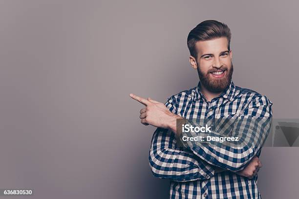 Cheerful Handsome Stylish Man Pointing To The Side Stock Photo - Download Image Now