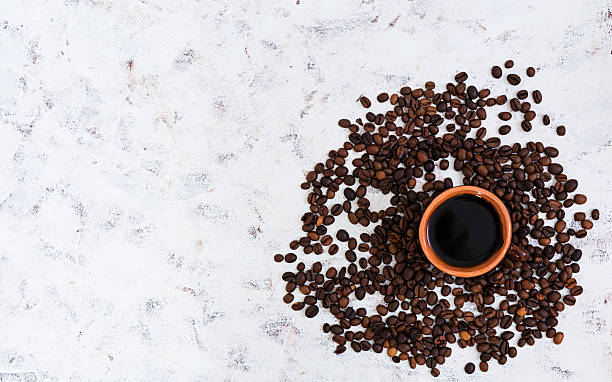 istock Coffee cup and coffee beans on white background. Top view 636830772