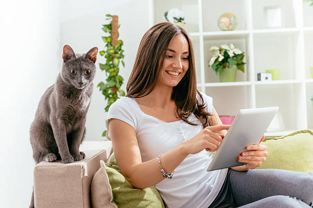 istock Woman having fun online with cat 636831206