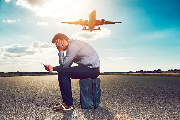 istock Frustrated passenger waits for plane while looking at phone 636831504