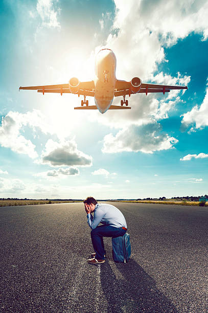 istock Frustrated and tired passenger waits for plane on runway 636831544