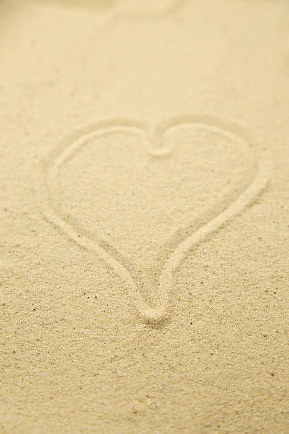 istock Heart drawn in the sand. Beach background. Top view 636836236