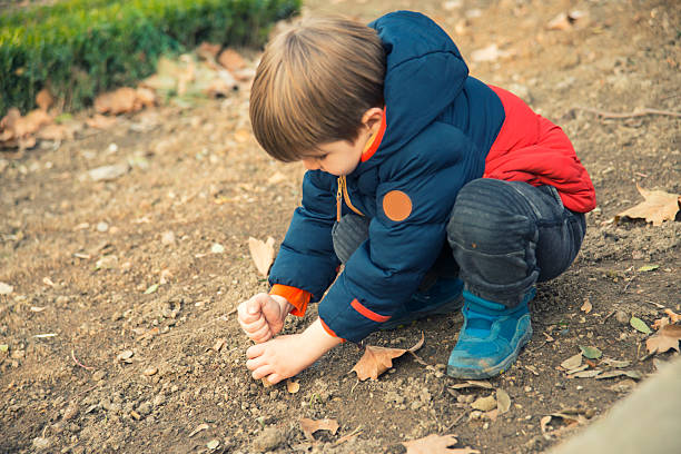 istock Little Boy Playing On The Ground 636838906