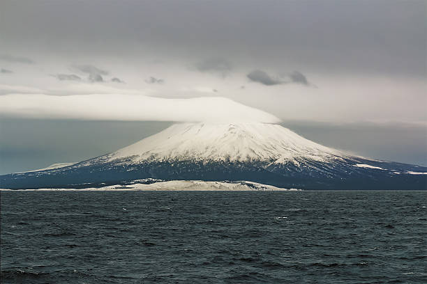 Tyatya volcano in the Kuril island of Kunashir The volcano a tyatya is one of the symbols of the island Kunashir island of the Kurils with a height of 1485 meters, the local population considers it the most beautiful volcano, and its ubiquitous in these parts the image is an unofficial symbol of the Kuril Islands. kunashir island stock pictures, royalty-free photos & images