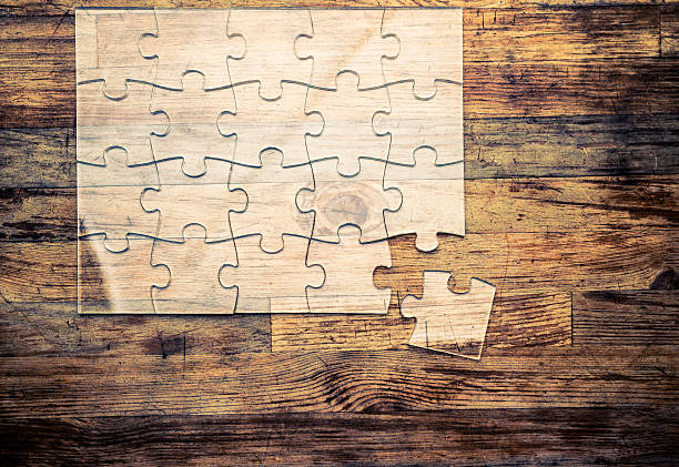 istock Transparent Jigsaw puzzle on wood background 636840160
