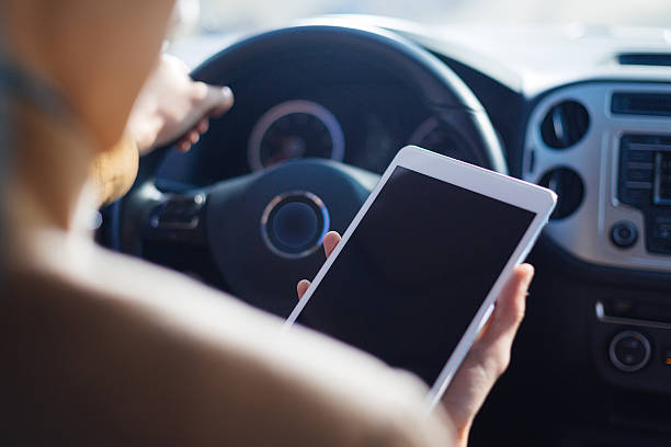 istock young asian man  hold tablet in car 636842414
