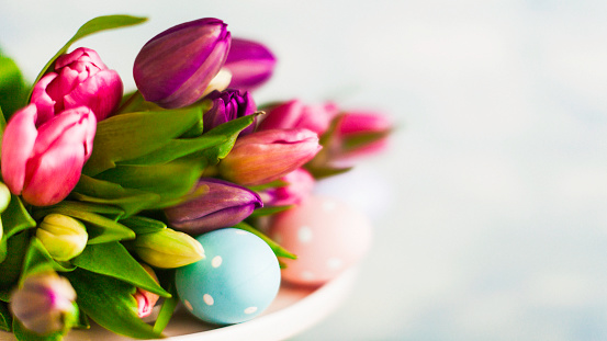 Easter arrangement with fresh tulips and Easter eggs