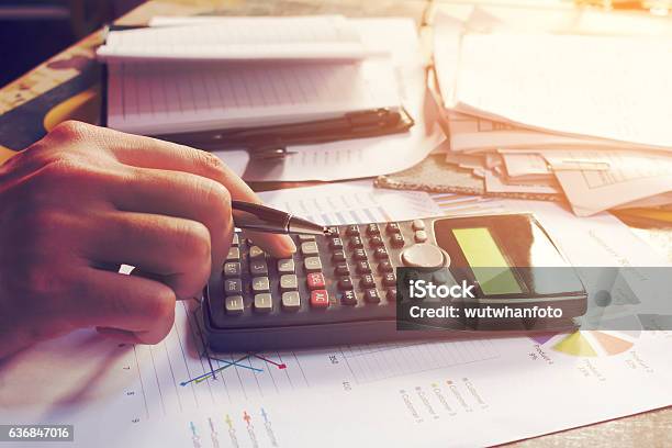 Close Up Man Using Calculator And Doing Finance In Home Stock Photo - Download Image Now