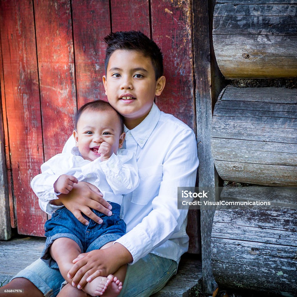 Filipino Boy Holding Baby Brother Outside Stock Photo - Download ...
