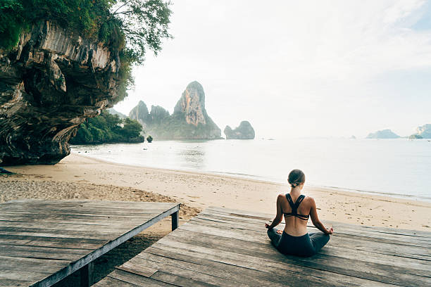 Woman doing yoga on the beach