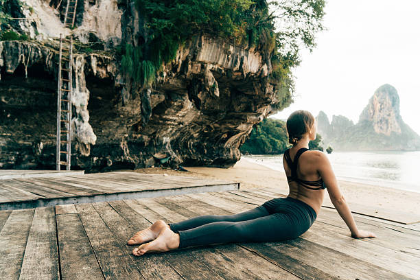 istock Woman doing yoga on the beach 636848410