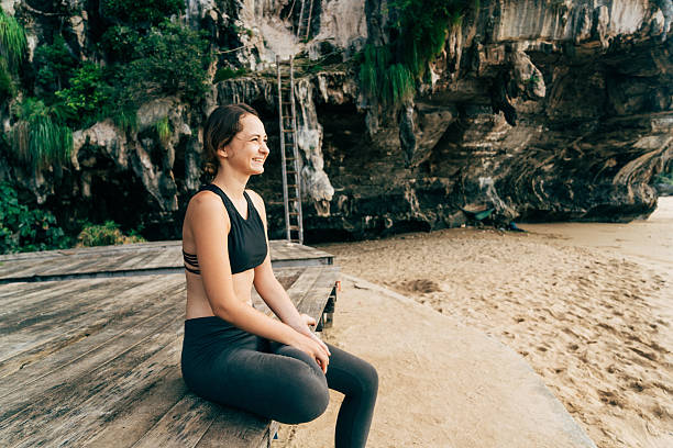 istock Woman sitting  on the beach 636848470