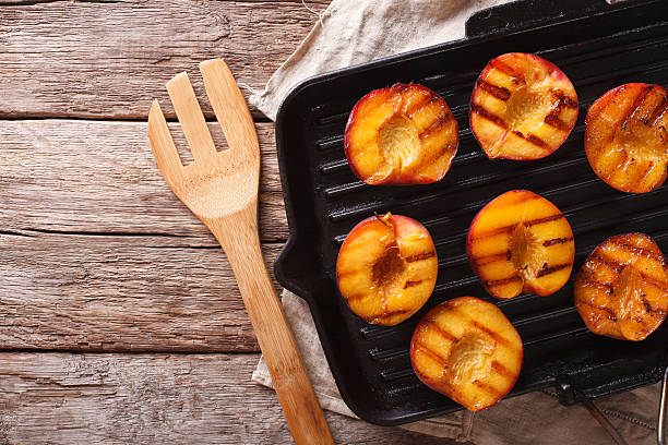 istock Cooking Ripe peaches on a grill pan close-up. horizontal 636851116