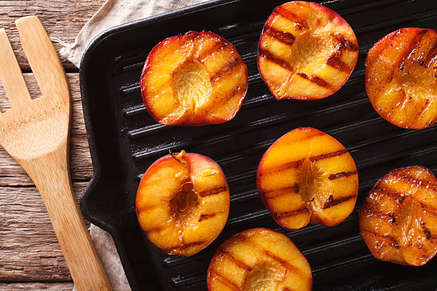 istock Ripe peaches on a grill pan close-up. horizontal top view 636851142