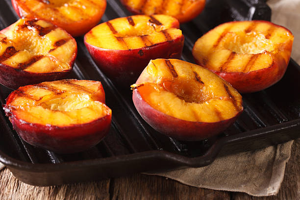 istock Ripe peaches on a a grill pan close-up. Horizontal 636851306