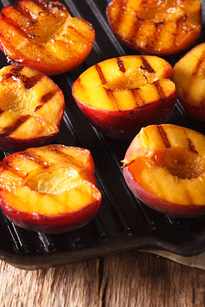 istock Ripe peaches on a a grill pan close-up. vertical 636851338