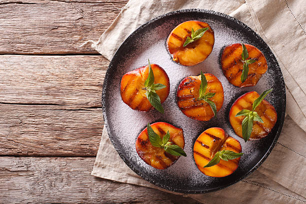 istock Ripe peaches grilled with powdered sugar and mint 636851458