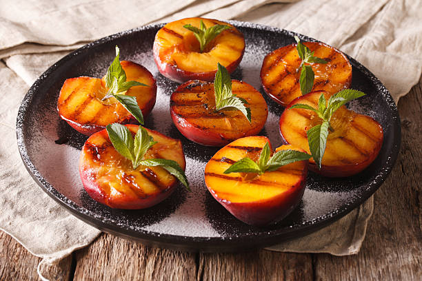 istock Summer dessert: grilled Peaches with powdered sugar and fresh mint 636851662