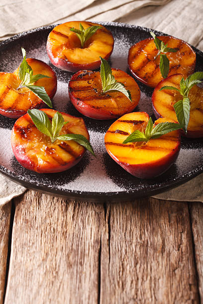 istock Healthy Dessert: grilled Peaches with powdered sugar and mint 636851752