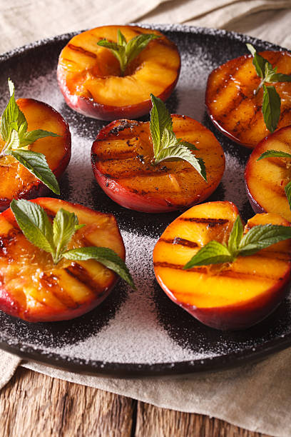 istock Ripe peaches grilled with powdered sugar and mint macro 636852500