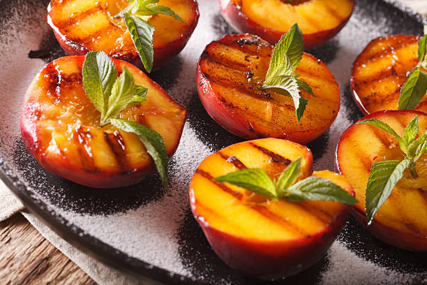 istock Ripe peaches grilled with powdered sugar and mint macro 636852542