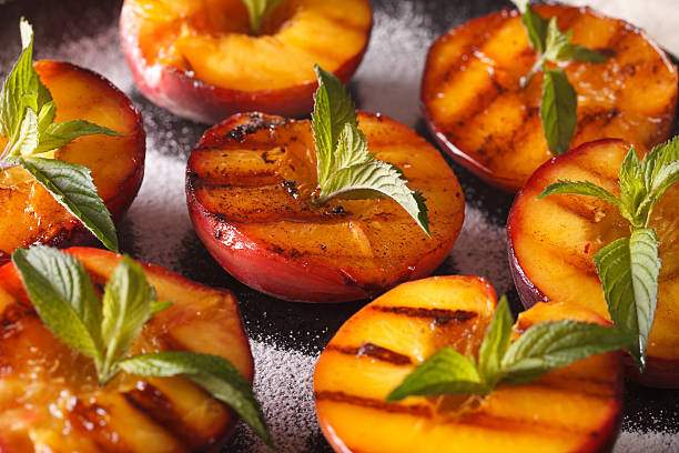 istock Grilled Peaches with powdered sugar and mint macro 636852578